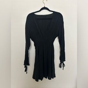 Zara long sleeve, short black dress with silver rings detailing the cuffs.
